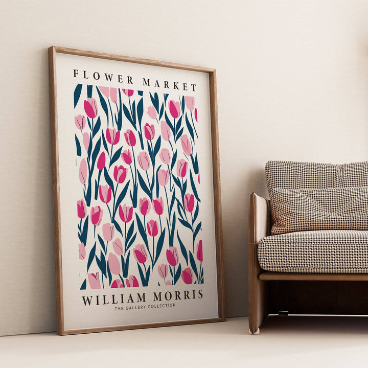 Tulip Decor framed print with pink tulips leaning against a cream wall beside a brown patterned sofa