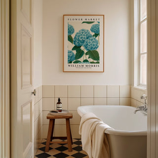 Flower Market Prints framed print of blue hydrangea flowers in a minimalist style above a wooden stool in a bathroom