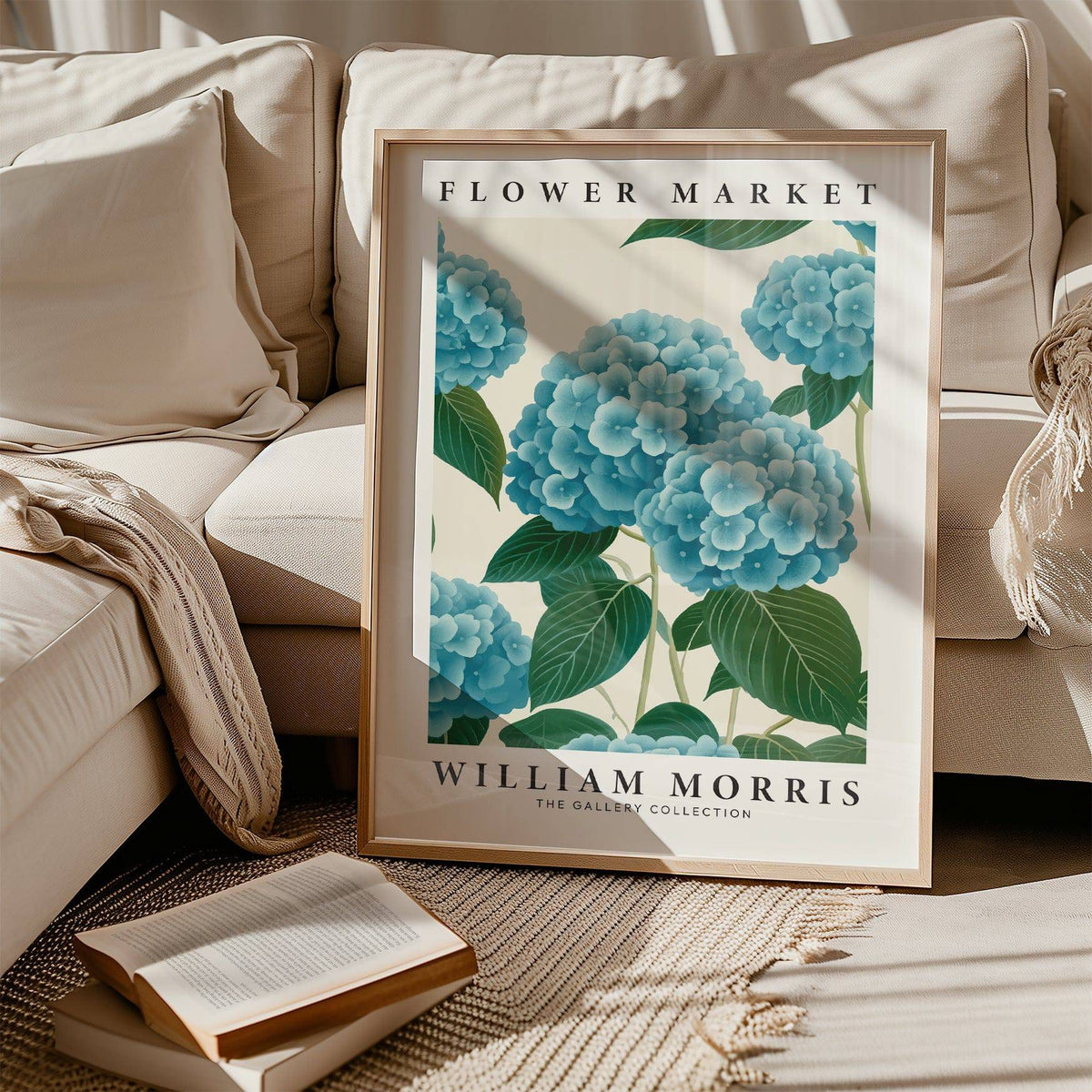 Flower Market Prints framed print of blue hydrangea flowers leaning on a sofa with cushions and books