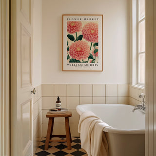 Pink wall decor of pink dahlia flowers in a minimalist style above a stool in a bathroom