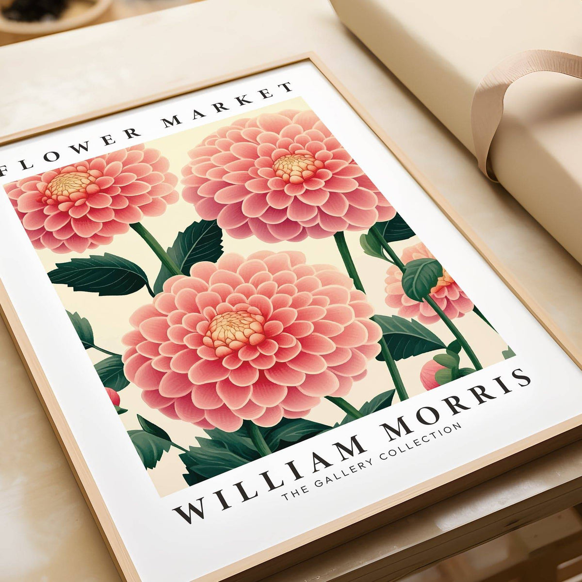 Pink wall decor framed close-up of pink dahlia flowers with green leaves beside a ribbon