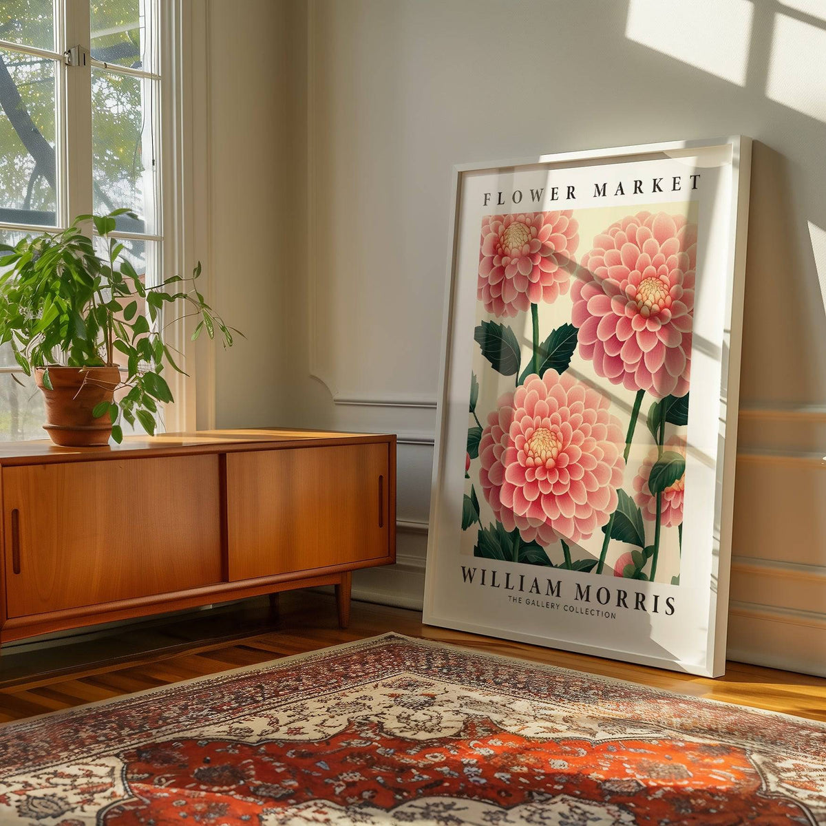 Pink wall decor leaning on a wooden floor with a patterned rug beside a sideboard and plant