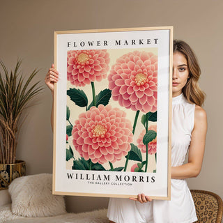 Pink wall decor held by person showing pink dahlia botanical illustration with cream background