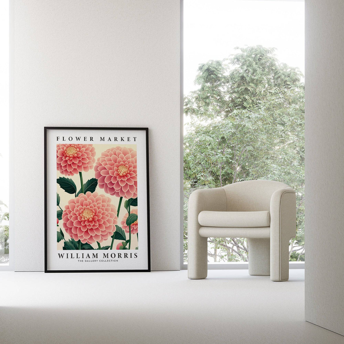 Pink wall decor with pink dahlia flowers in a black frame leaning beside a cream armchair
