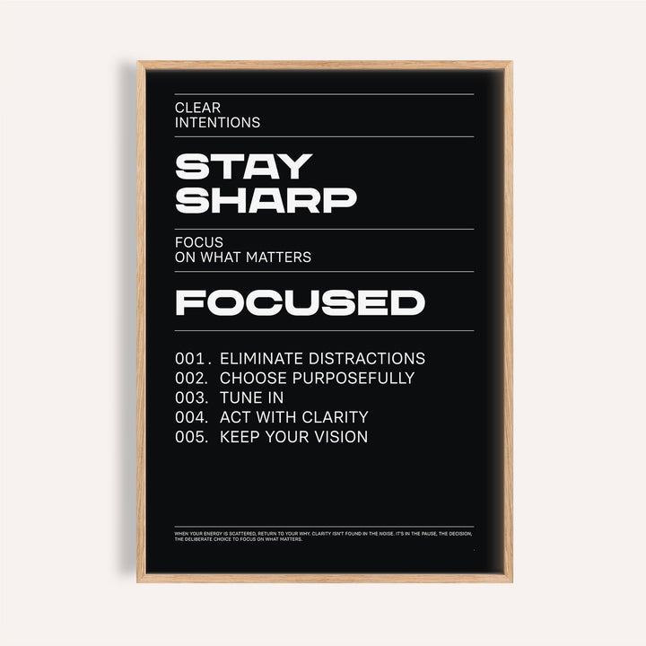 Stay Focused Poster with bold white text Stay Sharp on a black background in a wooden frame