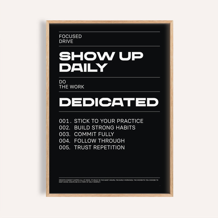 Framed print of a motivational text poster with white bold and regular text on a black background