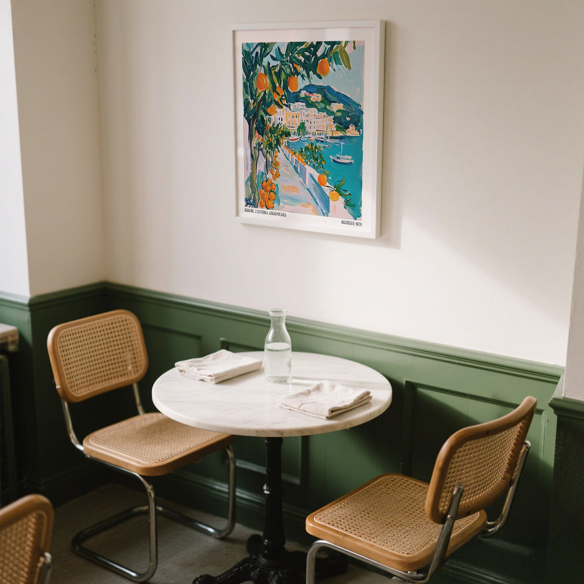 Art Prints of Italy wall art with an orange tree and seaside path above a bistro table