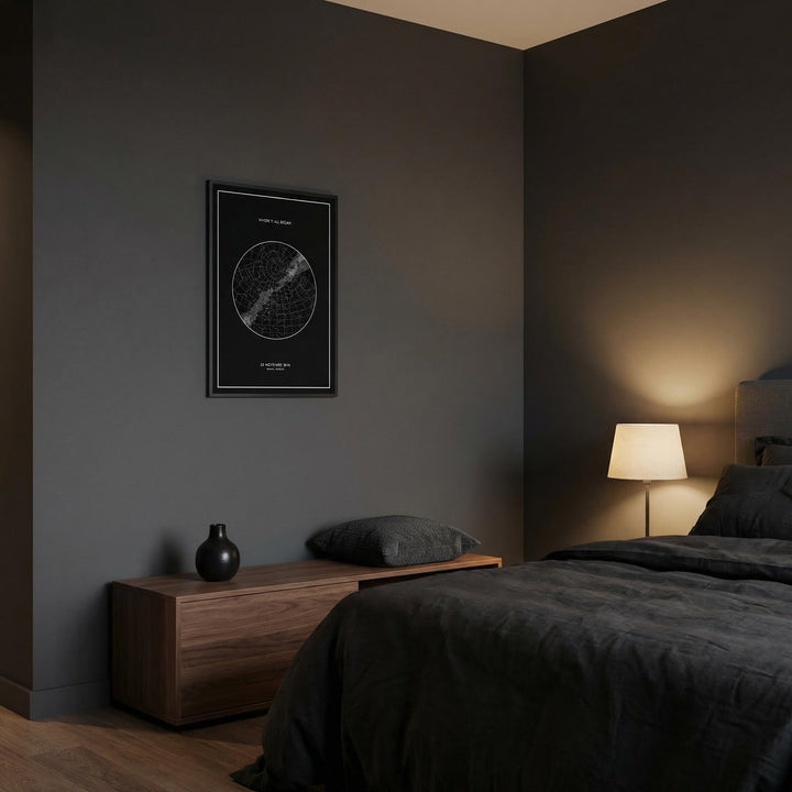 Custom Star Map framed print in a dark bedroom with a wooden bedside cabinet and lamp
