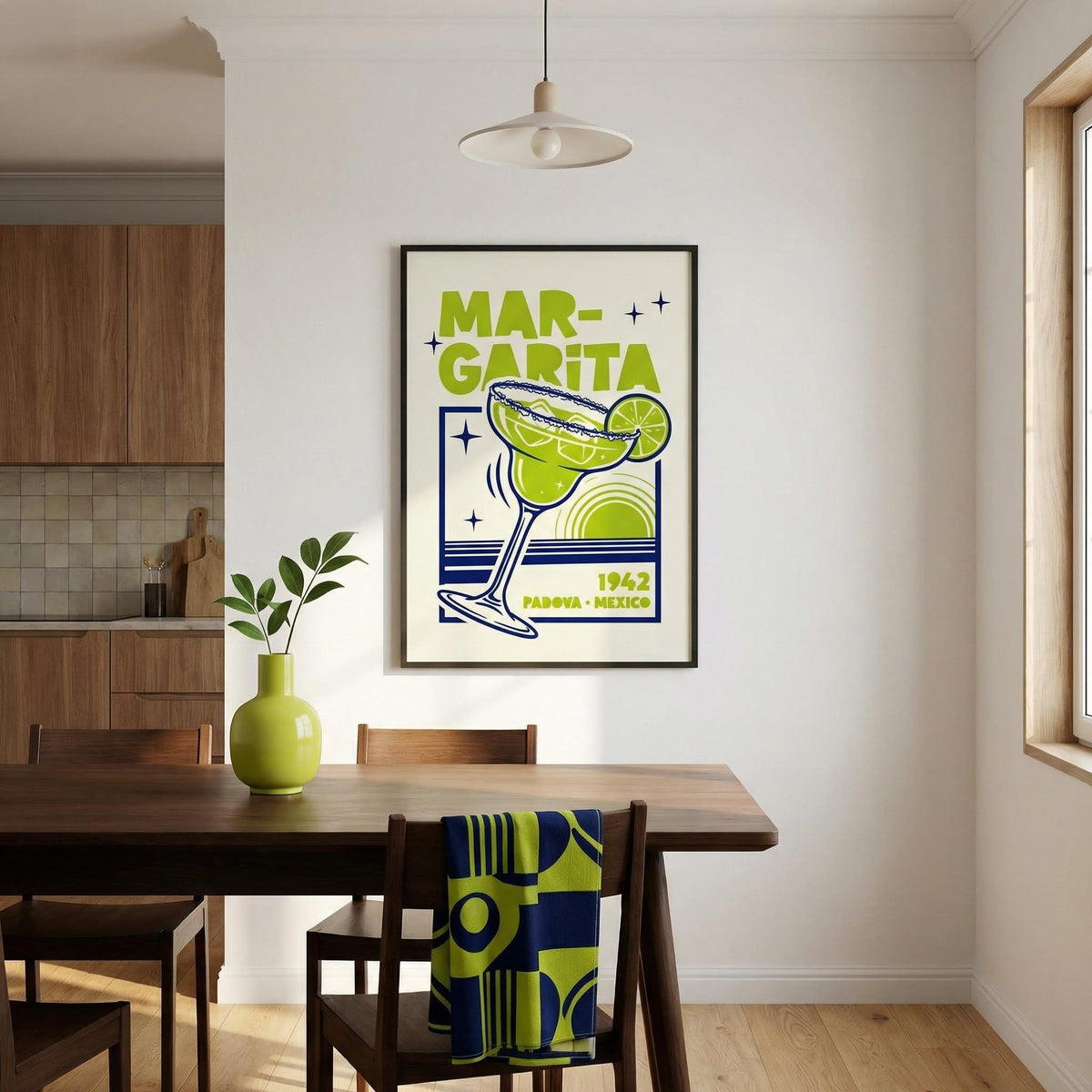 Margarita Art framed print in lime green and navy blue above dining table with green vase