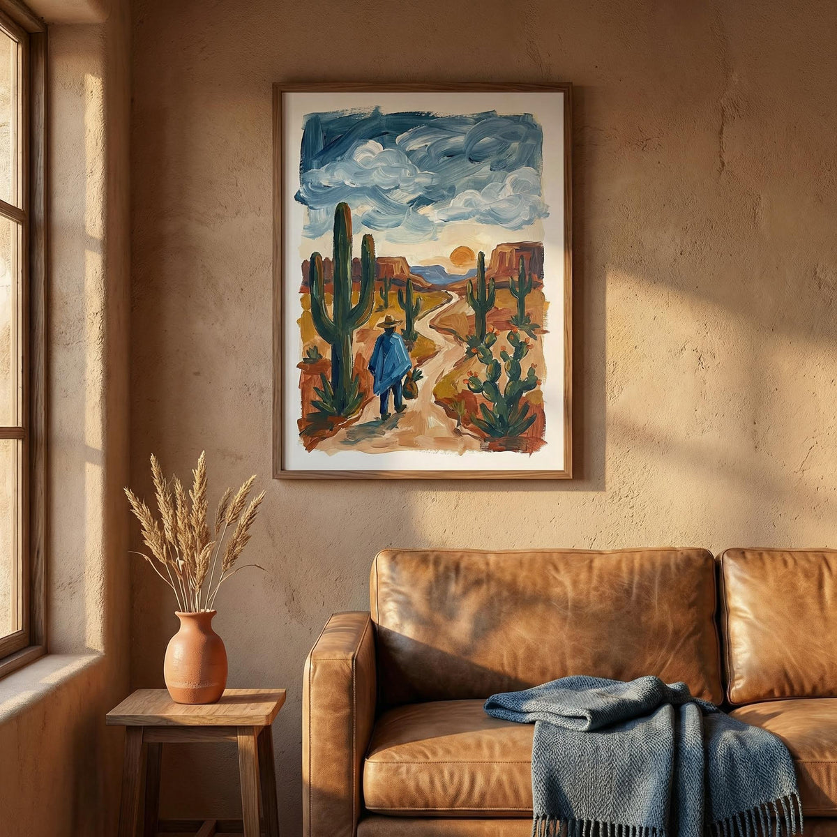 Sunset Cactus Poster Print in a room scene with warm light and a leather sofa with a blue throw