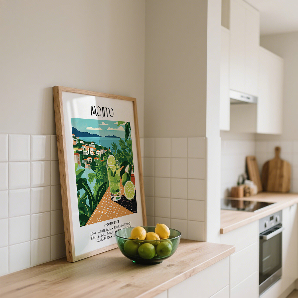 Cocktail print leaning on kitchen counter next to a bowl of lemons and limes