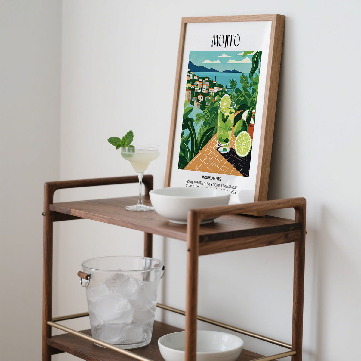 Cocktail print leaning on a wooden trolley next to a cocktail glass and ice bucket