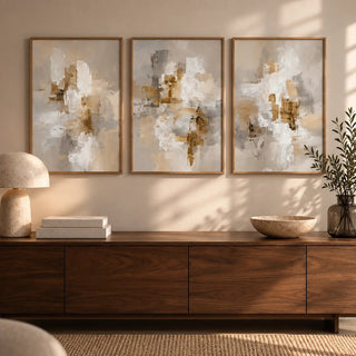 Neutral dining room wall art with neutral abstract shapes in beige and brown above a sideboard with a lamp