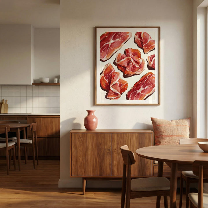 Print on a wall of the Parma Ham Poster with red and pink hues above a wooden sideboard with a pink vase in a dining room