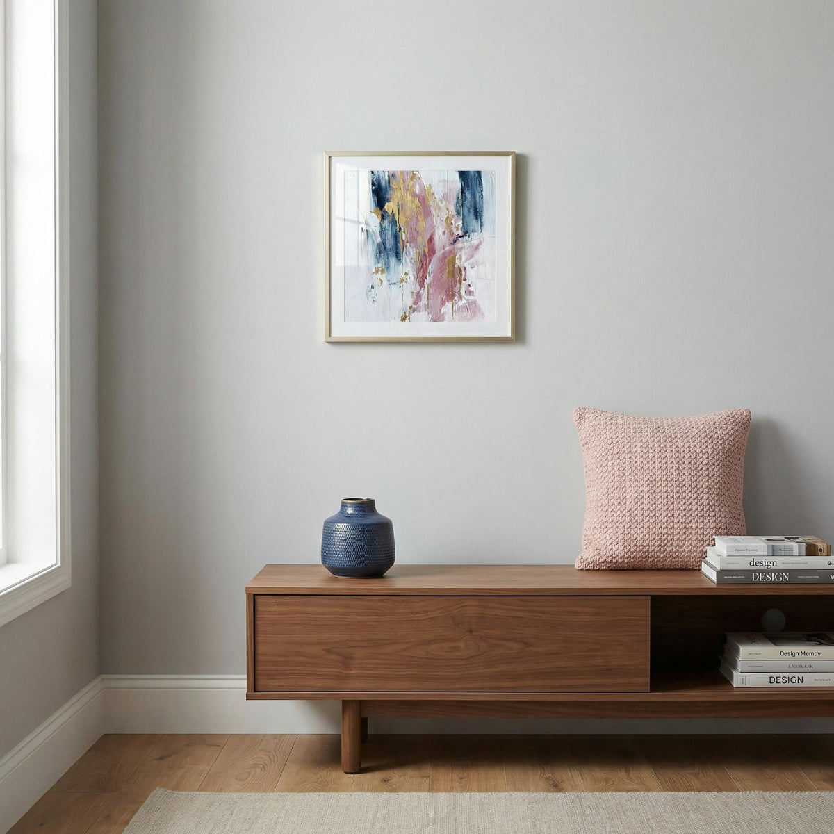 Pink Abstract Square Art framed print with pink and blue paint strokes above wooden sideboard