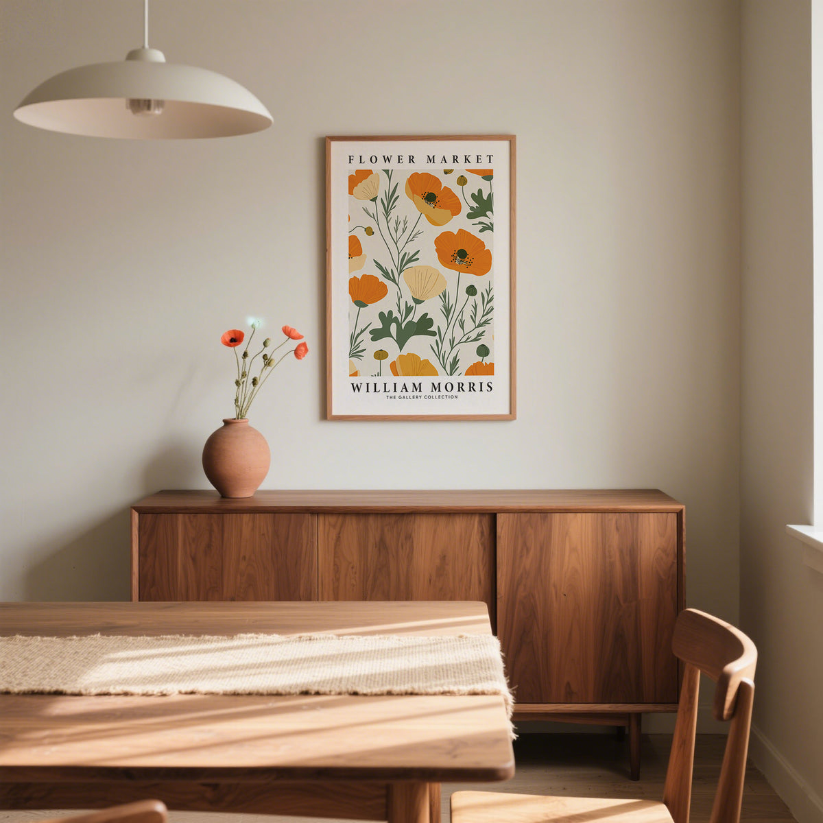 Wall Art Poppies print of orange poppy flowers in a wooden frame above a cabinet with a vase