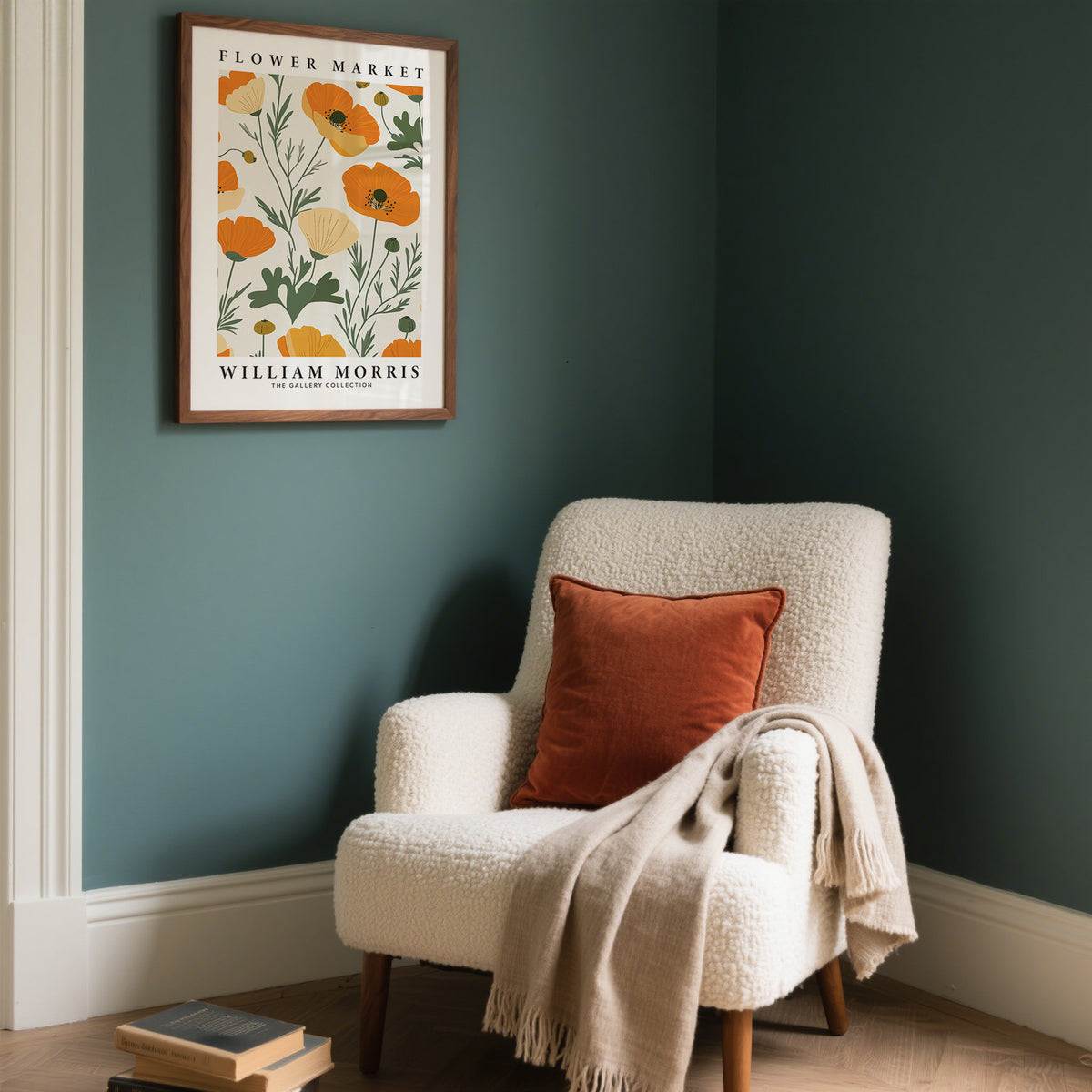 Wall Art Poppies minimalist orange and cream poppy print framed on a teal wall above a cream armchair with an orange cushion