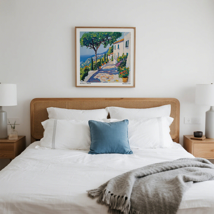 Prints of Amalfi Coast wall art of a Mediterranean path with trees and white houses above a bed with a blue cushion