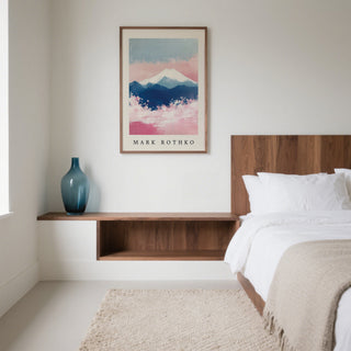 Mount Fuji art hanging above a wooden shelf with a blue vase in a minimalist bedroom