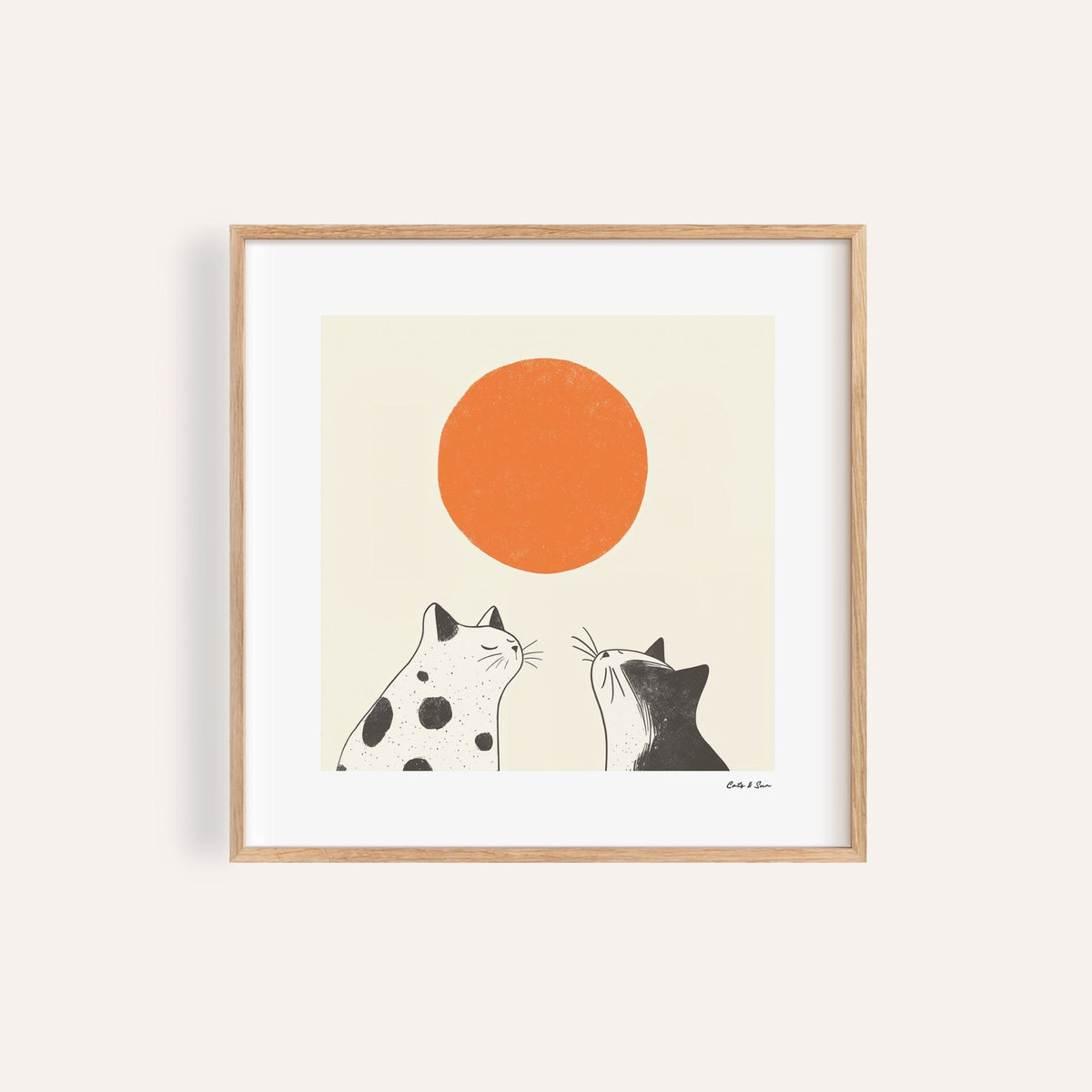 Framed print close-up of minimalist black and white cats looking at an orange sun