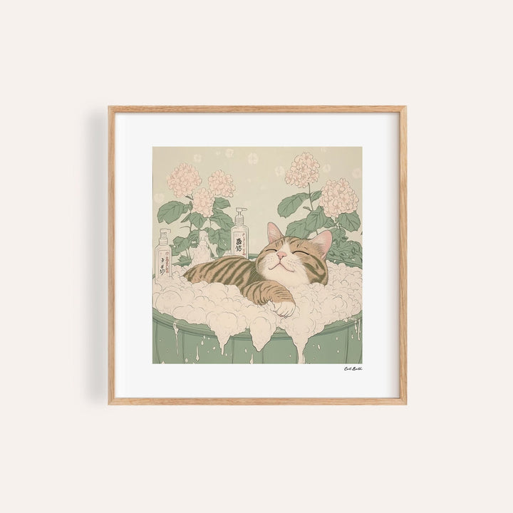 Framed print of a tabby cat relaxing in a bubble bath with pink flowers in background
