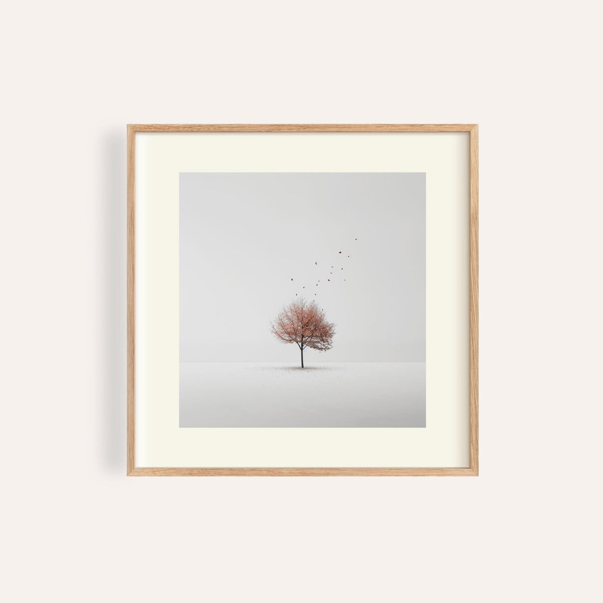 Framed Tree Wall Art of a minimalist tree with red leaves floating against a pale background