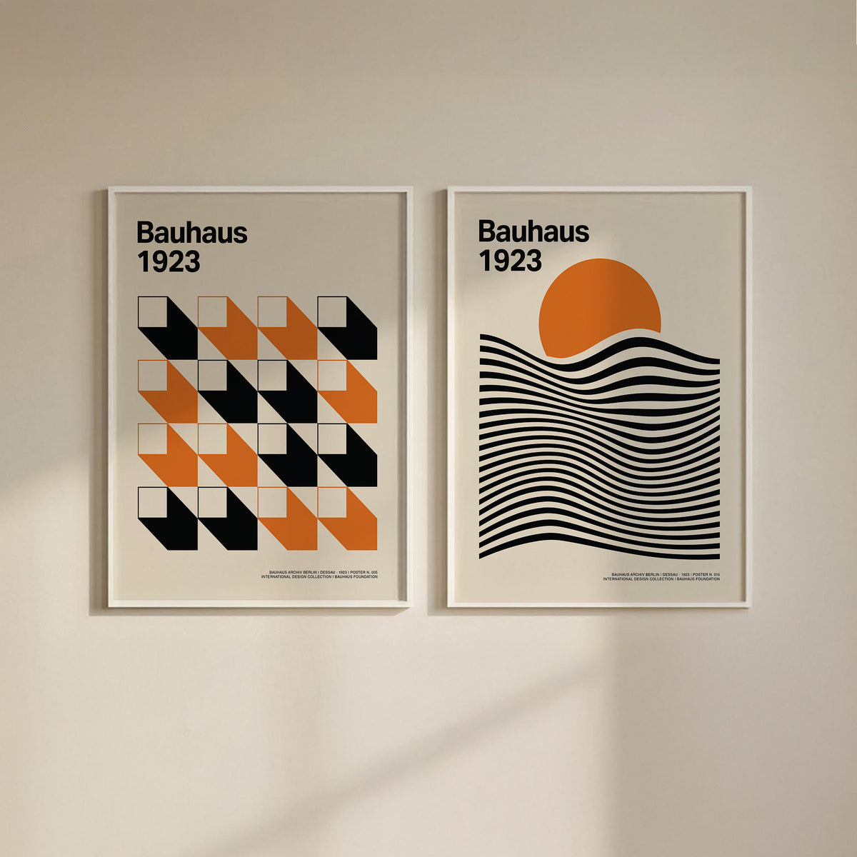 Bauhaus gallery wall art of geometric shapes in orange black and cream on a plain wall