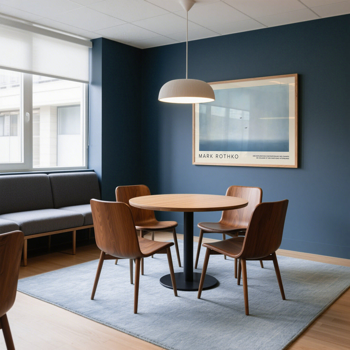 Wall Art Light Blue hanging above a round table with four chairs in a room with blue walls and a grey sofa