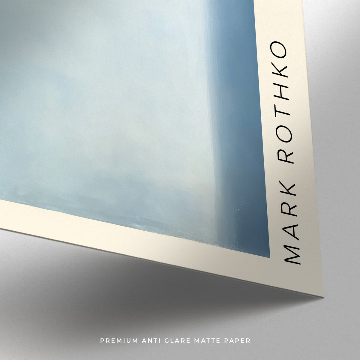 Detail close-up of light blue wall art showing smooth gradient and corner text