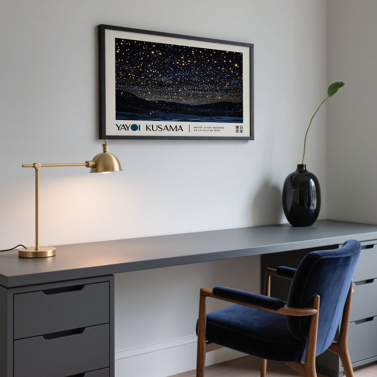 Night Sky Art framed print of a starry night sky above dark hills above a grey desk with a gold lamp and black vase