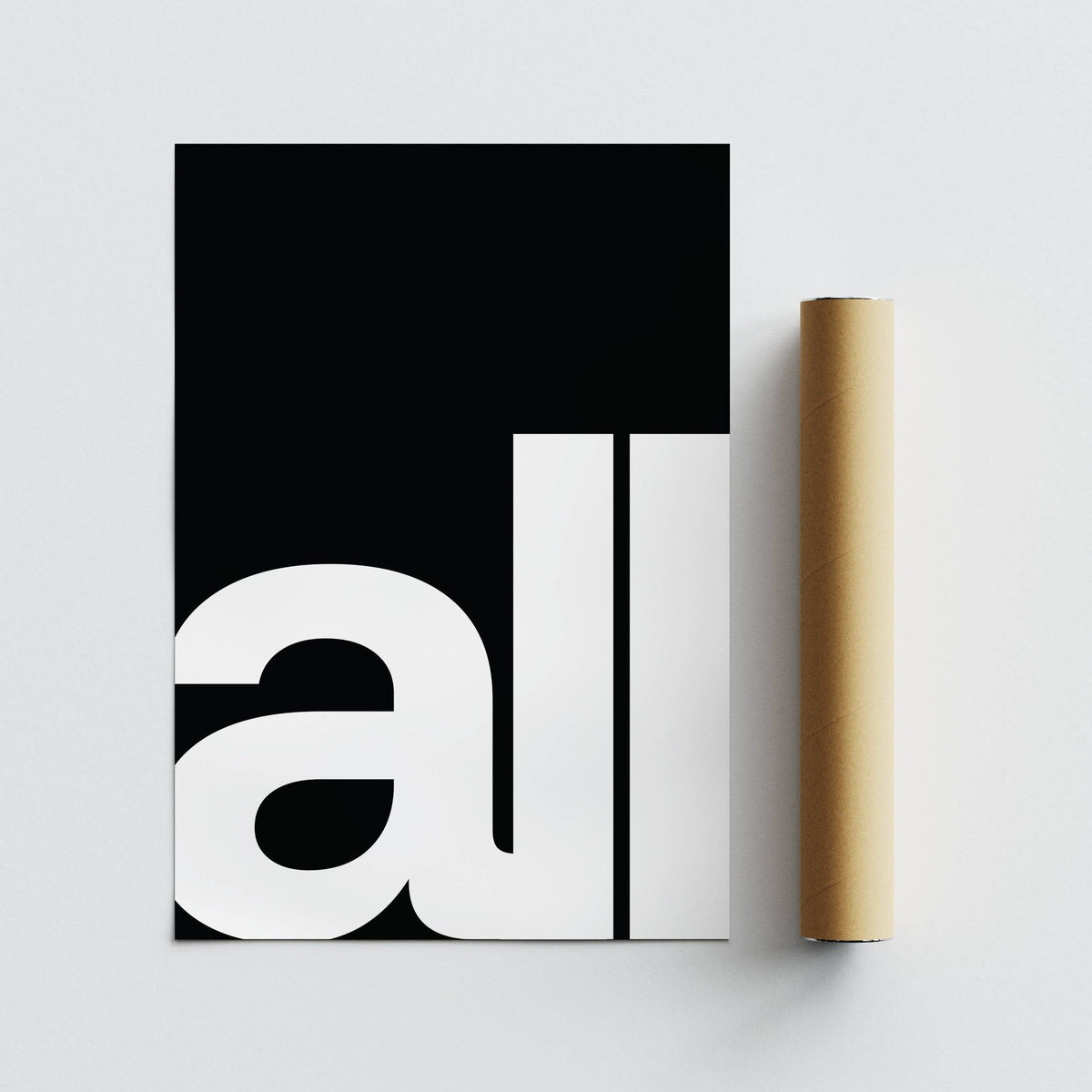 Typography art prints showing black and white minimalist 'all' text with packaging tube on white surface