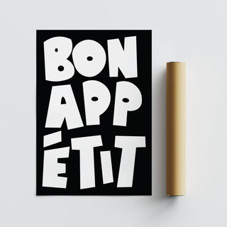 Bon appétit text wall art with white letters on black next to a packaging tube