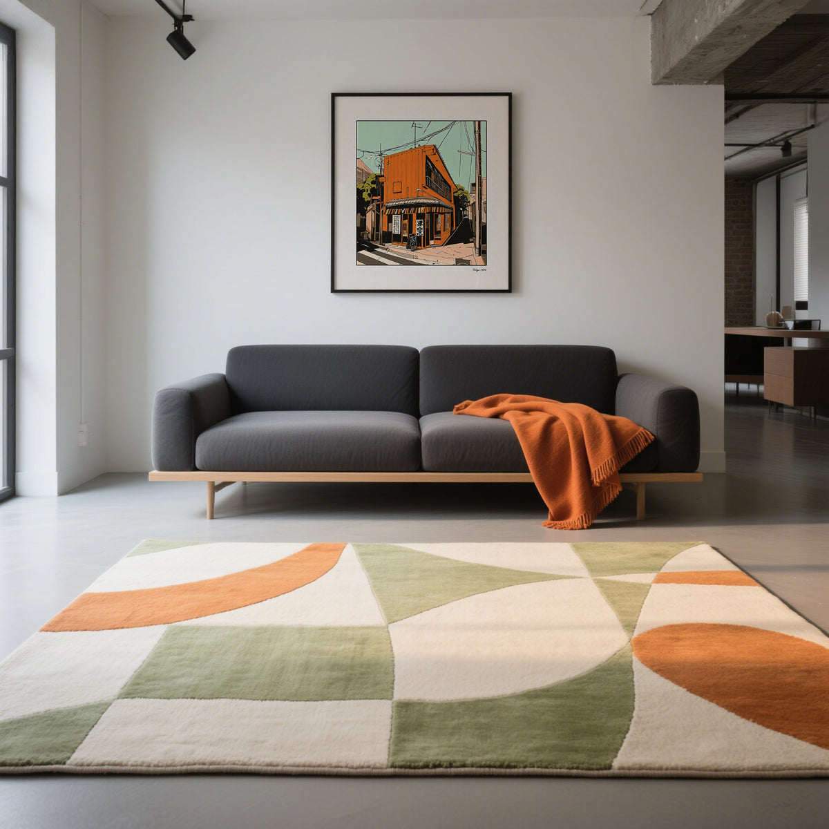 Tokyo wall art print of an orange street building hung above a dark grey sofa with an orange throw