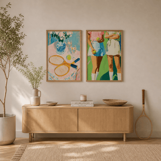 Prints of tennis rackets and players in bright colours on sideboard with a potted plant nearby