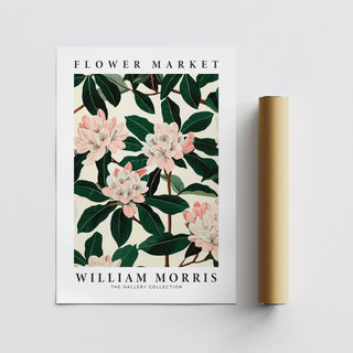 Magnolia wall art print with pink flowers and dark green leaves next to a brown packaging tube