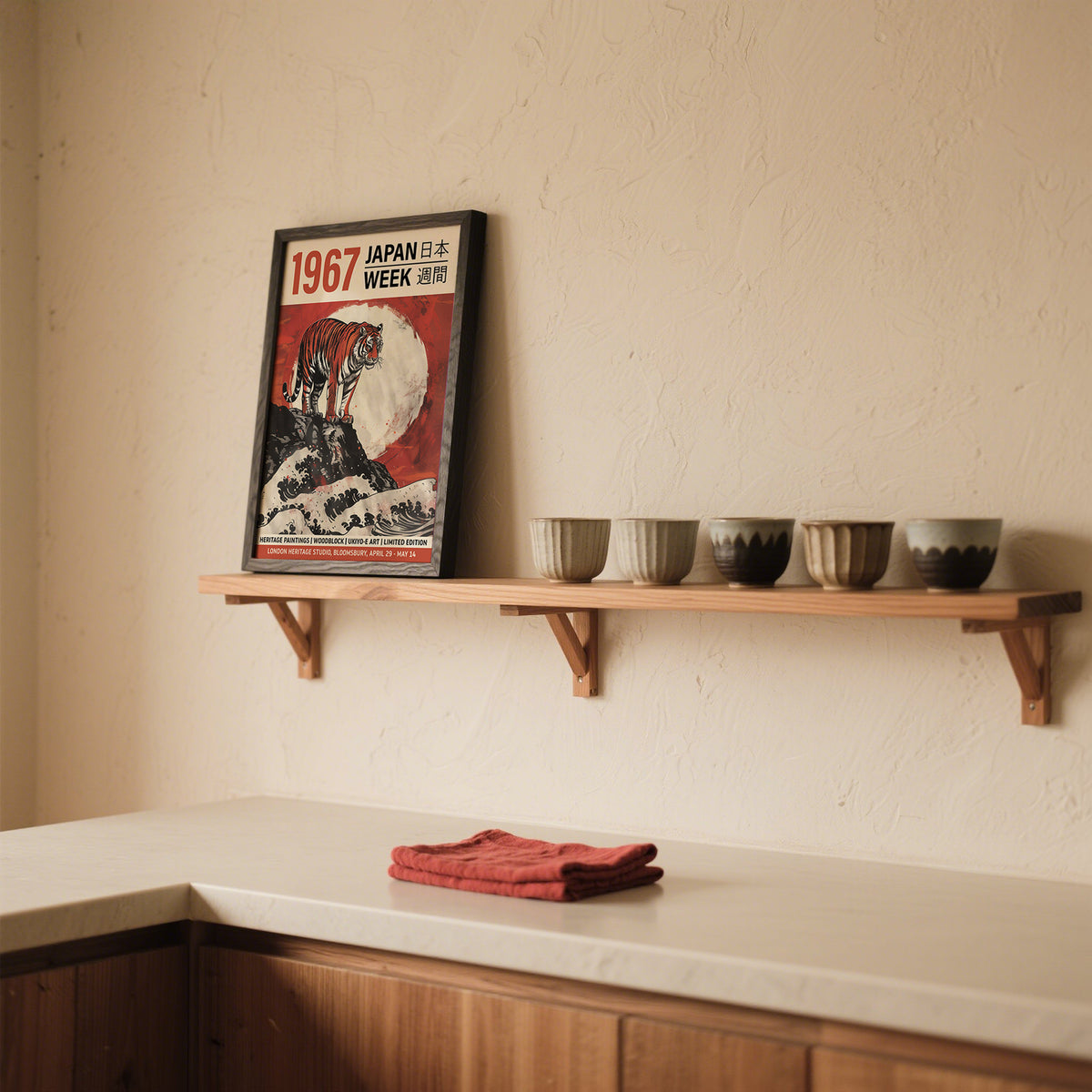 Framed Japanese Woodblock Prints artwork with tiger on rock and red moon above a kitchen shelf with four cups