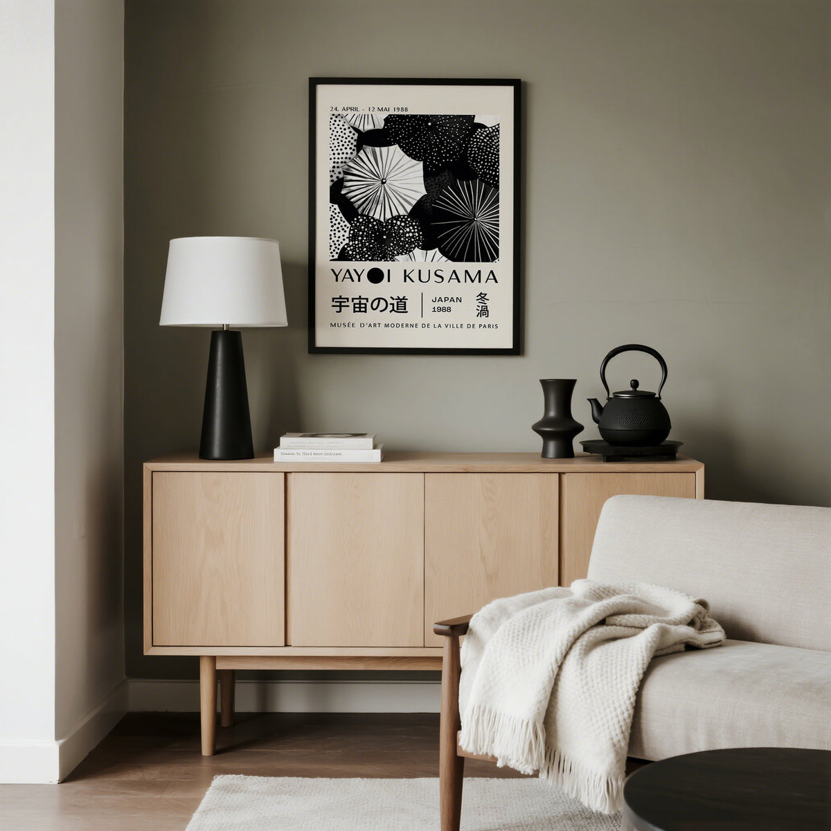 Winter wall art framed print with black and white abstract dots above a wooden sideboard and lamp