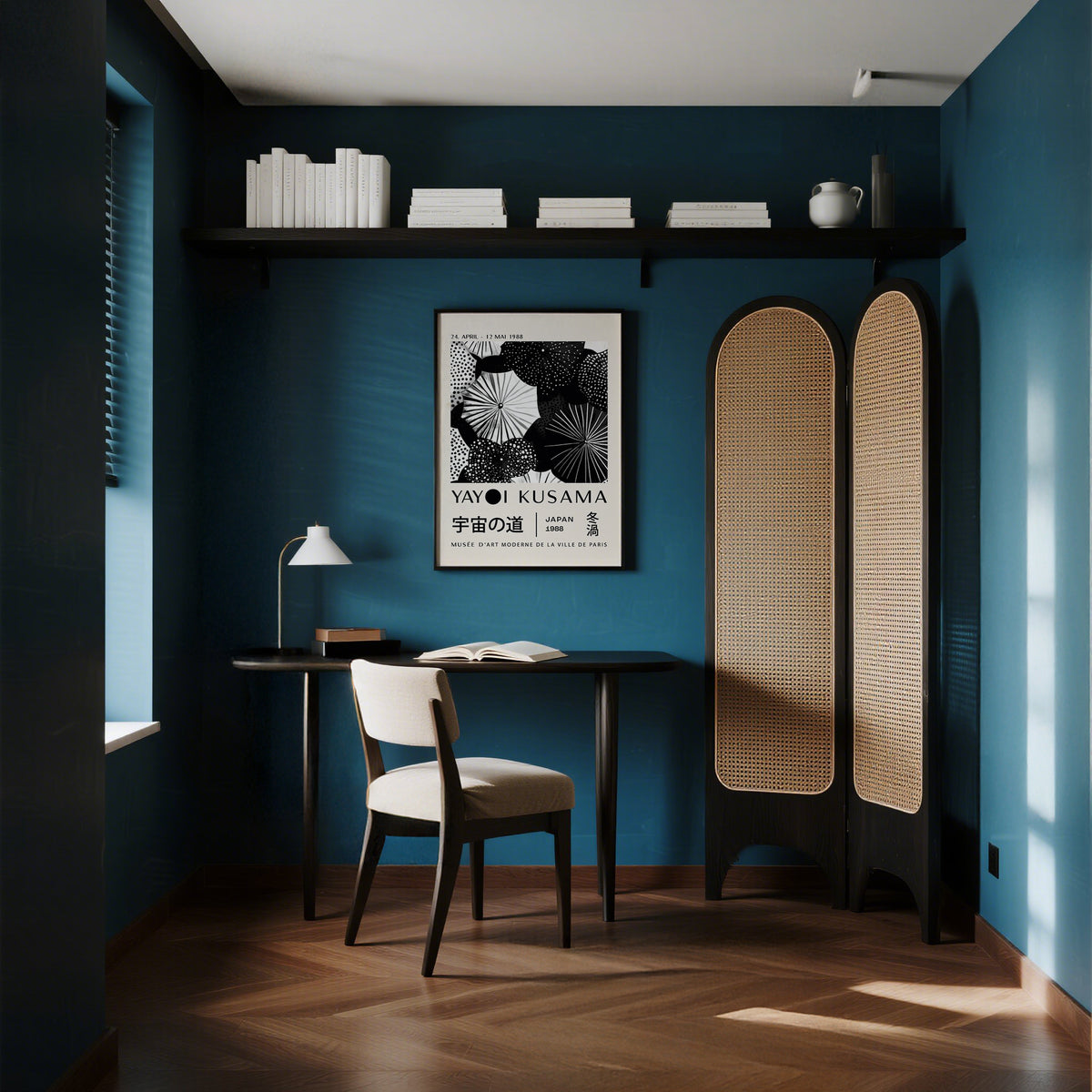 Winter wall art with black and white abstract dots framed on a teal wall above a desk lamp