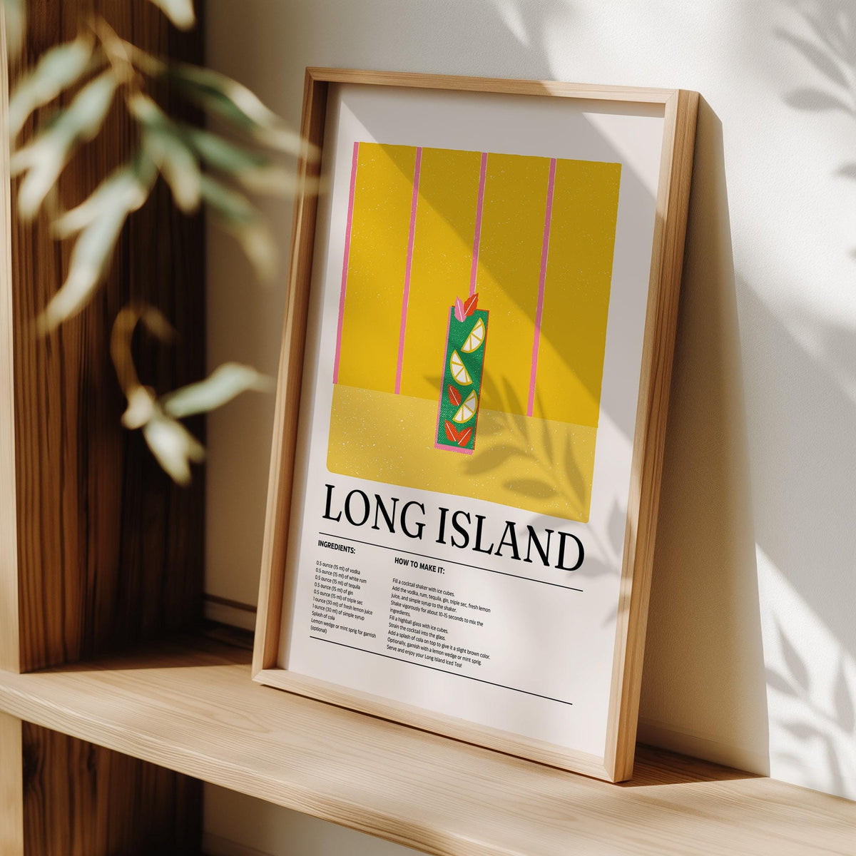 Print leaning on a shelf with a wooden frame and shadows on a yellow Long Island cocktail illustration