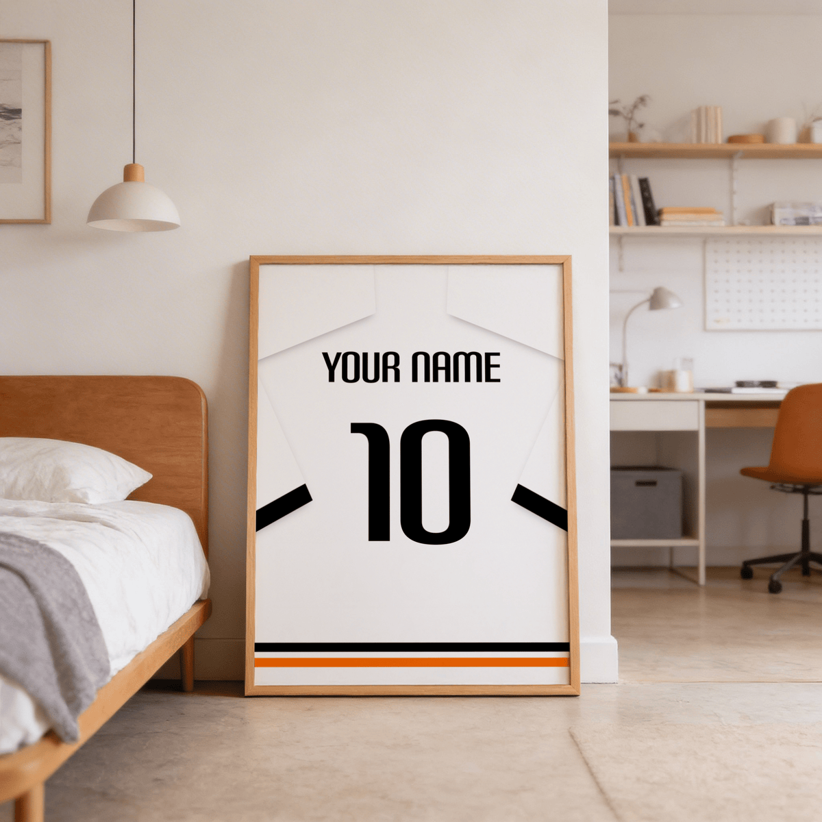 Print leaning on the floor of a bedroom with minimalist football shirt poster in white with black sleeve bands