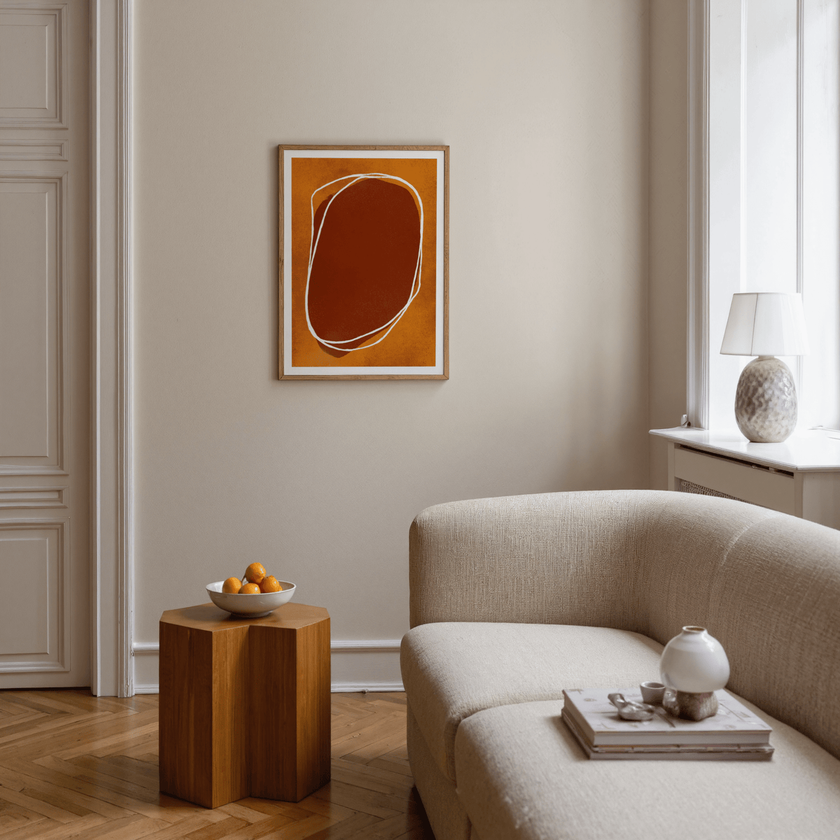 Abstract Earth Tone wall art with organic shapes in warm browns above a wooden side table in a living room