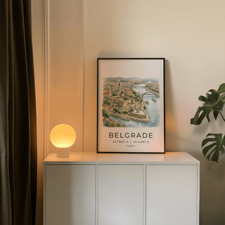Belgrade City Art Print leaning on a white cabinet with a round lit lamp and a green plant nearby