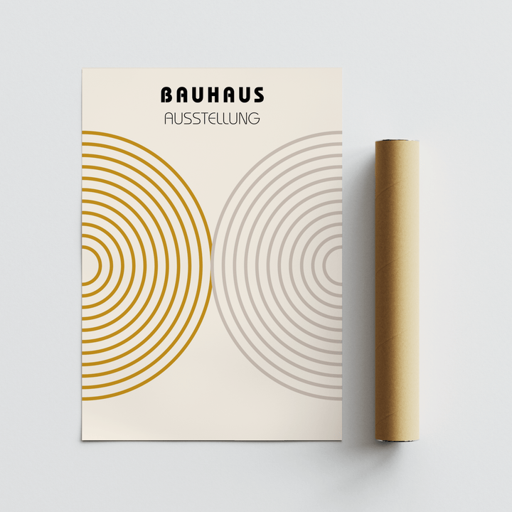 Minimalist wall decor with concentric circles in ochre and grey next to a brown packaging tube