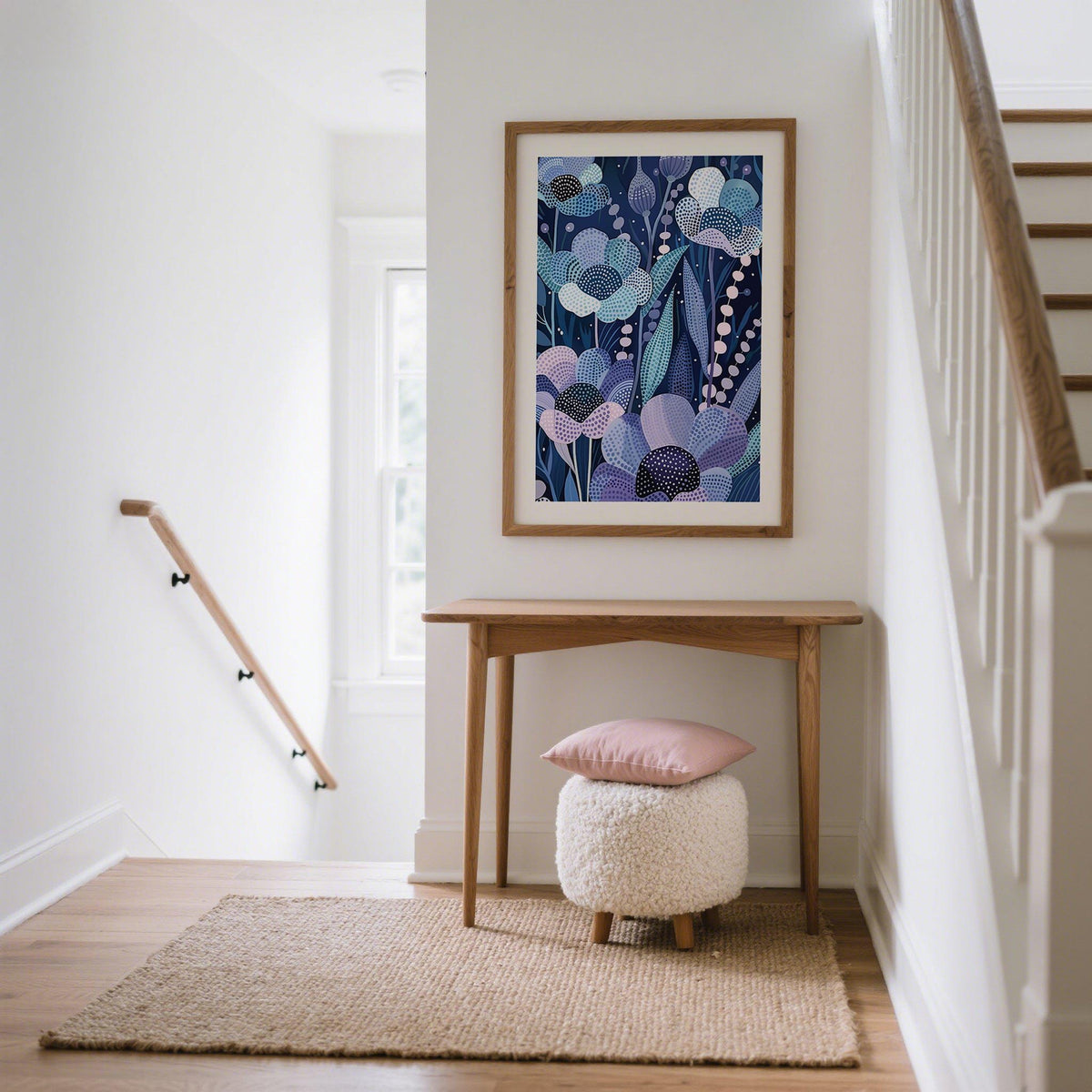 Modern Flower Art framed print of indigo floral pattern with pink and blue tones above a wooden table in a hallway