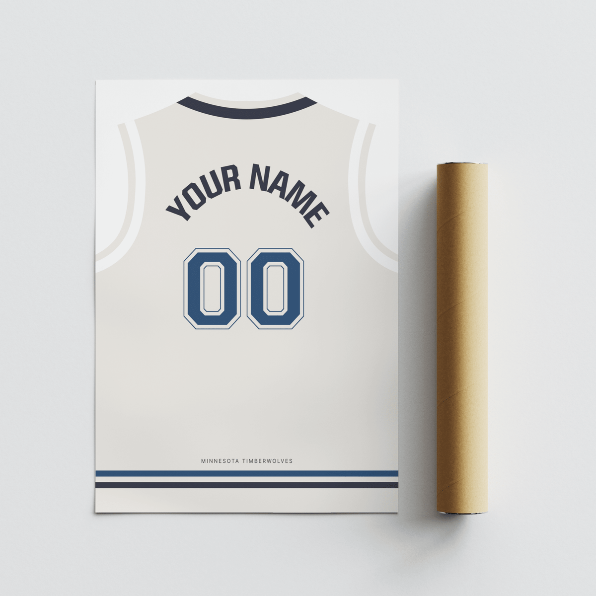 Flat lay of basketball jersey poster in white with navy number next to a brown packaging tube
