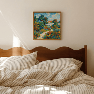 Colourful Flower Garden Print in a wooden frame above a bed with striped bedding in a bedroom