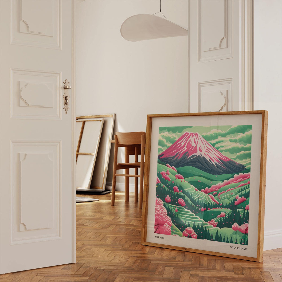 Mountain Landscape Art print leaning on the floor showing Mount Fuji with pink cherry blossoms in a pale room