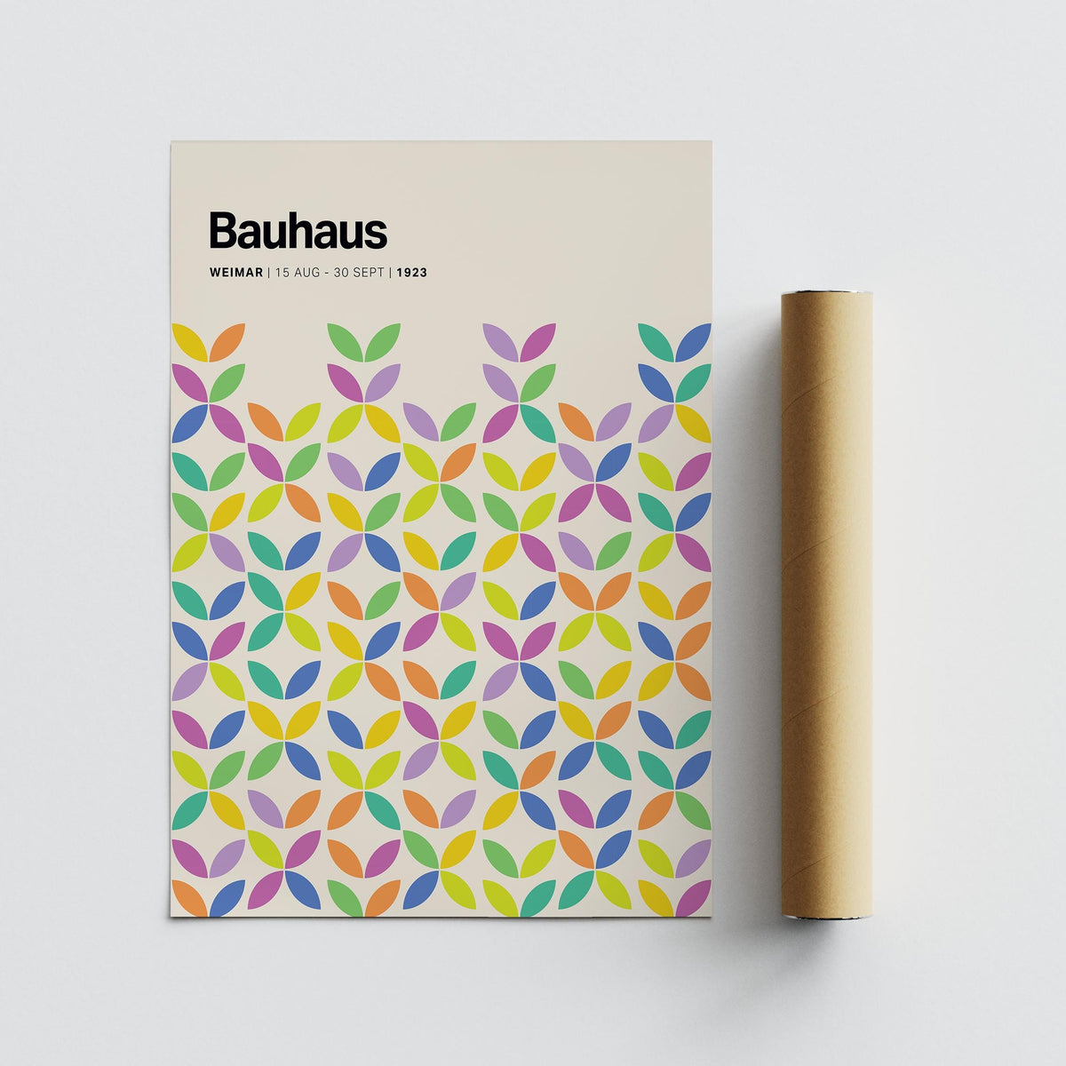 Colorful Bauhaus Poster flat with abstract colourful petals and a cardboard packaging tube beside it