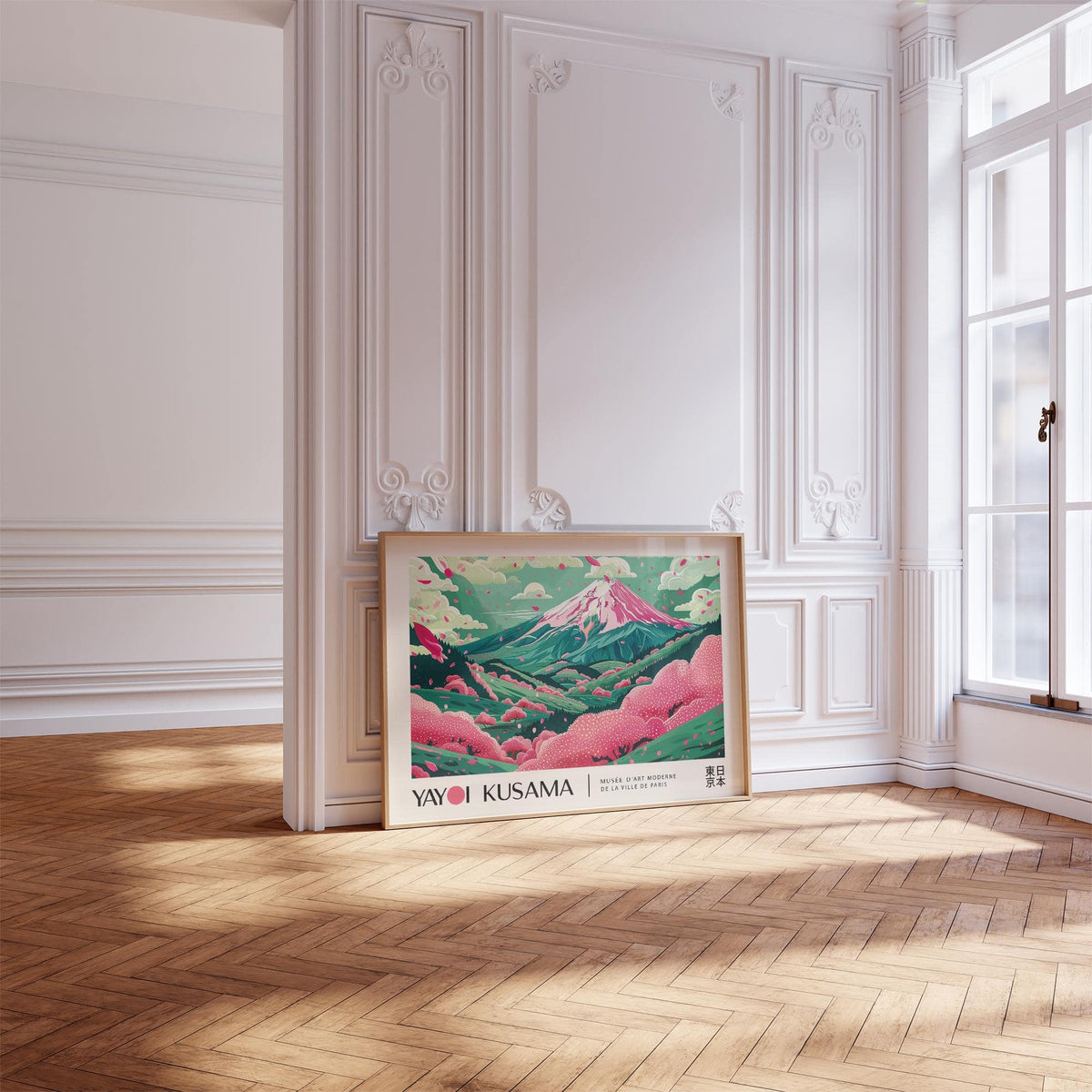 Print leaning on floor of cherry blossom art with pink hills and turquoise sky in a bright room