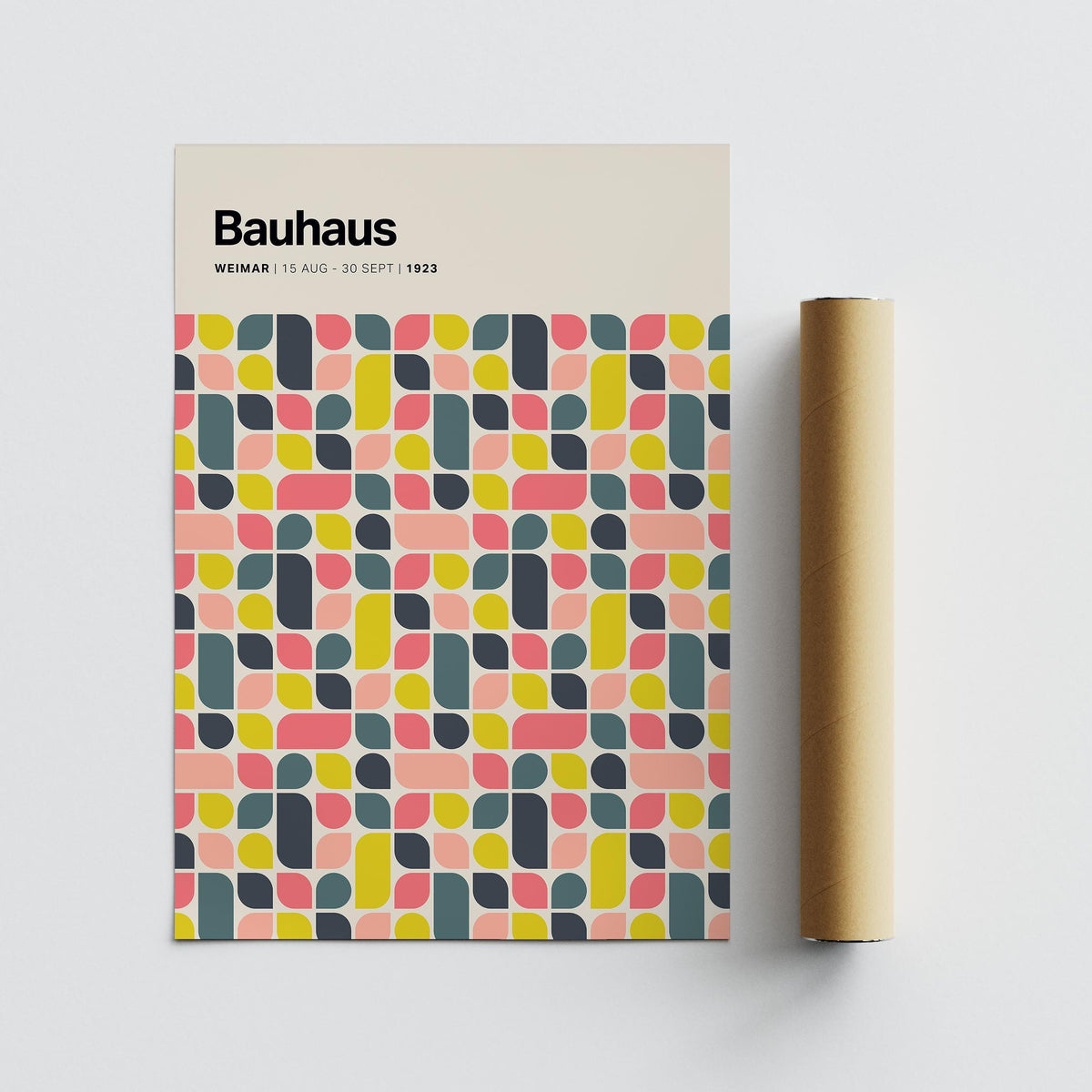 Bauhaus colourful wall poster flat on grey surface with a brown packaging tube